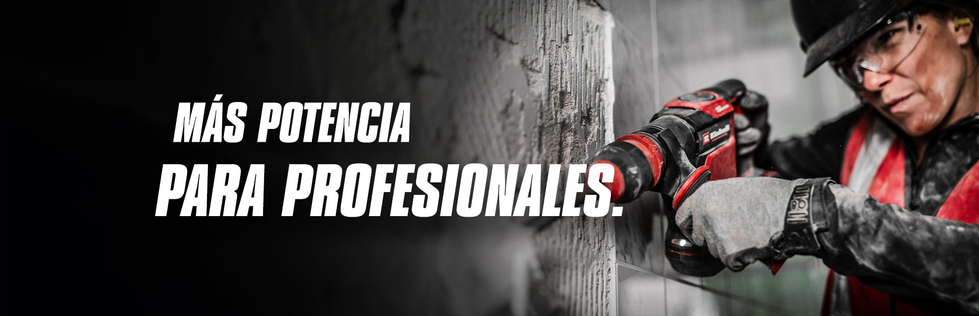Una persona con gafas de seguridad y casco usa un taladro rojo en una pared, con el texto "Más poder para Profesionales".