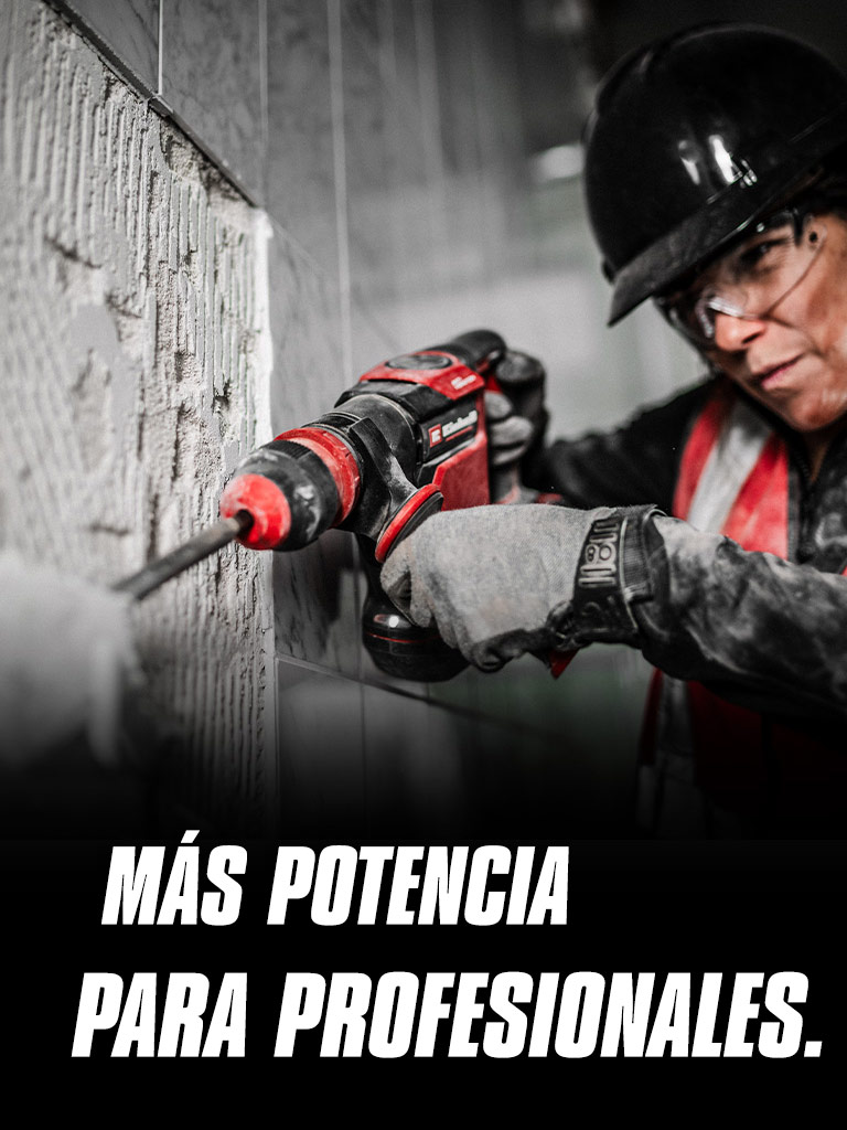 Una persona con gafas de seguridad y casco usa un taladro rojo en una pared, con el texto "Más poder para Profesionales".