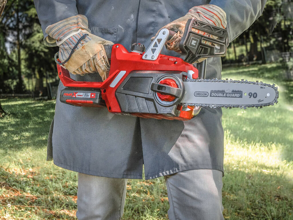 Someone holding a chainsaw.