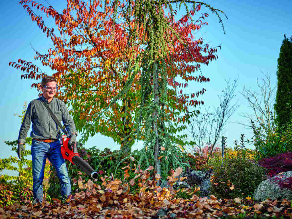 A man using the leaf blower. 
