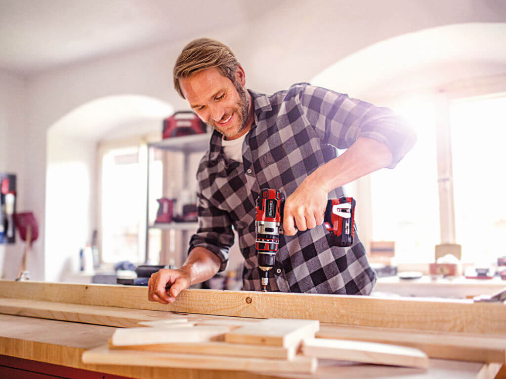 man working with einhell screwdriver