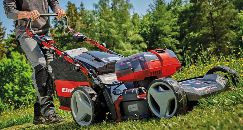 A large 36 V battery lawnmower with four battery slots and wheel drive.