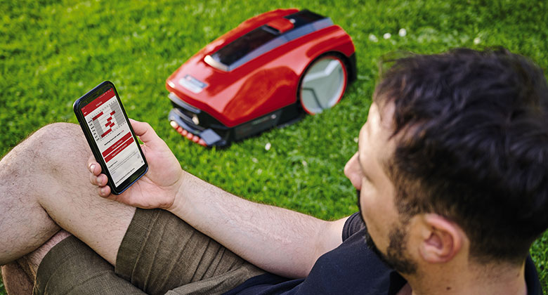 a man is using the Einhell Connect App to adjust the FREELEXOs